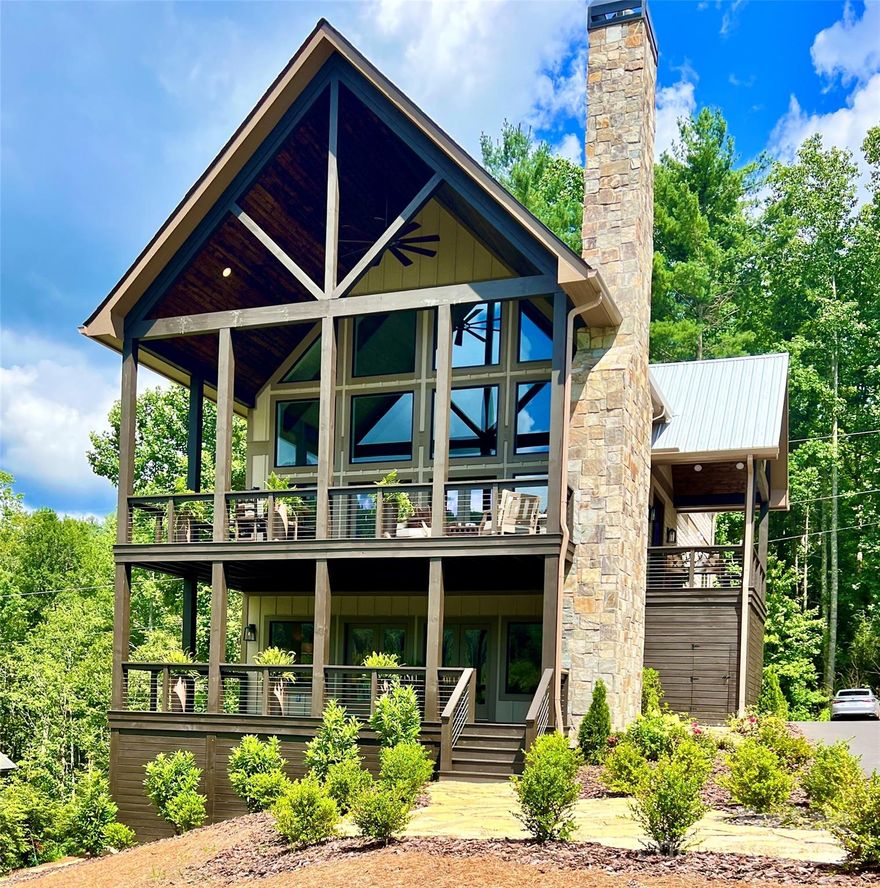 3 minutes from Lake Glenville and an easy 20 minute drive to Cashiers along the shores of Lake Glenville. BRAND NEW home with long range SUNSET MOUNTAIN VIEWS framed by a pasture, ponds, and a native trout stream.  OPTION TO PURCHASE FULLY FURNISHED (ALL BRAND NEW FURNISHINGS) for an additional fee.  (3 Finished levels 4 Bed 3.5 Bath) Finished +-3500 sq. ft. on a +-1.5-acre lot in an exclusive enclave of four rustic chic mountain homes. A 30’ glass wall, towering stone fireplaces. Expansive covered decks frame the serene landscape, with the stream’s  murmur enhancing the ambiance from the main deck or master suite’s private balcony.  Finished Terrace level with 10' ceilings perfect for teens/in-laws with separate bed/bath. W/Wet Bar and large TV/gathering/exercise room.  WARRANTY INCLUDED!

open-concept design unites kitchen, dining area, and great room, flowing seamlessly to a covered outdoor living area with another majestic stone fireplace.  Owner/Broker