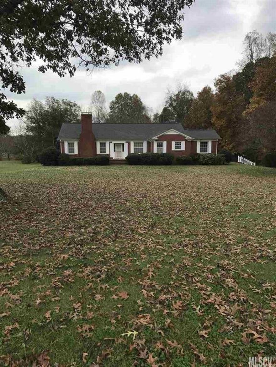 Spacious brick ranch with unfinished basement on 2.130 acres.  3 Bedrooms  3 Bath Crouch built  home with beautiful wood floors. Bright kitchen with eating area and abundance of cabinets.  Gas log fireplace in large living room.  Formal dining room has chair railing.  Den has gas wall unit and exterior door.  There is a walk up attic.  Convenient to 321, Hwy 10, Hwy 70 and I 40