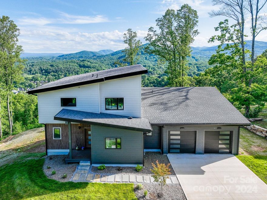 This stunning Mountain Modern home offers the perfect retreat for those seeking a harmonious balance
of nature and contemporary living. Boasting sleek, clean lines and high-end finishes, this artfully appointed home is a testament to style and sophistication. Floor-to-ceiling windows frame panoramic views of the surrounding mountains, creating a seamless connection between indoor and outdoor living spaces. The open-concept design invites natural light to flow throughout the home, highlighting the beauty of the modern interior.
The gourmet kitchen is a chef's dream, featuring state-of-the-art appliances, custom cabinetry, and a
large center island perfect for entertaining. The spacious living area is ideal for relaxing by the fireplace
or hosting guests, while the luxurious master suite offers a private sanctuary with a spa-like ensuite bath
and expansive walk-in closet. Outside, the property is a paradise waiting to be explored.