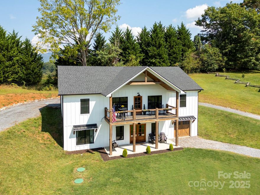 Welcome to this stunning newer-construction retreat in the heart of Haywood County. Built in 2021, this 4-bedroom, 3-bathroom home offers 2,858 square feet of thoughtfully designed living space that perfectly balances comfort, style, and functionality. From the moment you arrive, you’ll feel the peace and privacy of the countryside—yet enjoy the convenience of being only minutes from downtown Waynesville and a quick connection to I-40 for Asheville, Knoxville, or beyond.

Step inside to a bright, open floor plan that instantly impresses. The vaulted ceilings with exposed beams, wide-plank hardwood floors, and walls of windows bring in abundant natural light and highlight the home’s modern farmhouse charm.

At the heart of the home, the gourmet kitchen is a true showstopper: quartz countertops, a copper farmhouse sink, stainless steel appliances, custom cabinetry, and a large island with seating for four—perfect for gathering with family and friends. A walk-in pantry with a rustic sliding door adds both function and character.

The kitchen flows seamlessly into the spacious family room, where a stone fireplace with a reclaimed wood mantel creates the perfect centerpiece. Whether you’re hosting holiday gatherings or enjoying quiet evenings by the fire, this space is warm and inviting. The adjacent dining area offers plenty of room for entertaining, with direct access to the covered porch where you can soak in expansive mountain views.

The main-level primary suite is a private sanctuary, complete with a spa-inspired en-suite bath and generous closet space. Three additional bedrooms and well-appointed baths ensure plenty of room for family, guests, or a home office.

Downstairs, the finished lower level provides a versatile bonus space—ideal as a media room, game room, or second living area. With direct outdoor access, it’s perfect for both entertaining and everyday living.

Outdoor living is just as special here. A covered porch invites you to relax and take in the sweeping views of the mountains and rolling countryside, while the landscaped yard provides space to garden, play, or simply breathe in the fresh mountain air.

Additional highlights include a two-car garage, energy-efficient construction, and timeless finishes that make this home move-in ready.

This is more than a house—it’s a lifestyle. A place where every detail has been crafted to create comfort, beauty, and connection to the surrounding mountains. Whether you’re seeking a full-time residence or a luxurious getaway, this Haywood County gem offers the perfect blend of modern luxury and Appalachian charm.

Don’t miss your chance to make it yours.


Showings begin Friday September 26th