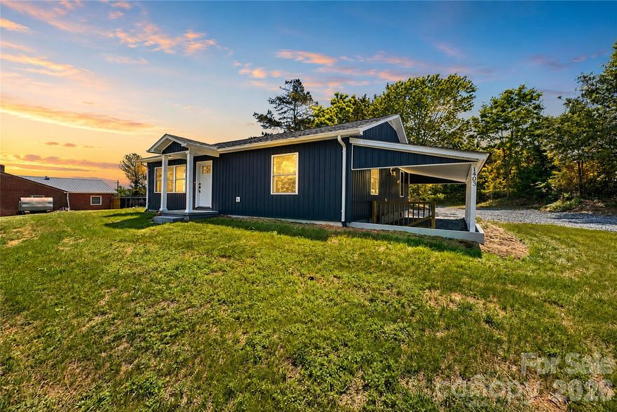 403 Dudley Shoals Road offers the perfect blend of timeless character and extensive modern renovation, creating a beautifully updated home with elevated finishes, functional living spaces, and exceptional everyday comfort just minutes from Granite Falls, Hickory, and Lenoir.

Originally built in 1959, this home has undergone a significant transformation with major system and cosmetic updates throughout, offering buyers the peace of mind and style that are often difficult to find at this price point. Renovations include all new electrical, all new plumbing, new HVAC, new windows, a new roof, new water heater, and a completely redesigned interior that blends modern finishes with warm, inviting living spaces.

Inside, the home immediately opens into a spacious open-concept layout where the kitchen, dining, and living areas flow seamlessly together. Walls were thoughtfully removed during the renovation process to create a more functional and connected floor plan, allowing the main living areas to feel bright, open, and ideal for both entertaining and everyday living.

The kitchen serves as one of the home’s standout features with custom sage green cabinetry by Allen + Roth, beautifully accented with gold hardware and designer-inspired finishes throughout. Stone countertops, subway tile backsplash, stainless steel appliances, recessed lighting, and abundant cabinet storage combine to create a space that feels both elevated and highly functional. The warm wood accents, clean lines, and modern color palette give the kitchen a custom-designed feel rarely found in homes within this category.

Luxury vinyl plank flooring runs throughout the home, complementing the neutral tones and cohesive modern aesthetic carried through each room.

The bathroom has been completely updated with stylish finishes including a striking mosaic tile floor, updated vanity, modern fixtures, and a clean contemporary design that enhances the overall upscale feel of the home.

Both bedrooms offer comfortable living space, natural light, and flexibility for a variety of lifestyle needs, while the overall layout provides an easy and functional flow throughout the home. Just off the kitchen near the side entry, the home also features a dedicated laundry area for added everyday convenience and functionality.

One of the property’s most valuable features is the expansive unfinished basement, accessible from both the interior of the home and the exterior near the covered side carport. This space offers exceptional storage capacity along with workshop, hobby, utility, or organizational potential rarely found at this price point.

Situated on approximately 0.79 acres, the property offers a private setting with open outdoor space, additional gravel parking, a covered side carport, and room to enjoy both practicality and privacy.

Whether you are searching for a fully renovated primary residence, your first home, or a move-in-ready property with modern updates and long-term value, 1403 Dudley Shoals Road delivers an impressive combination of quality renovations, designer finishes, functional storage space, and everyday livability.