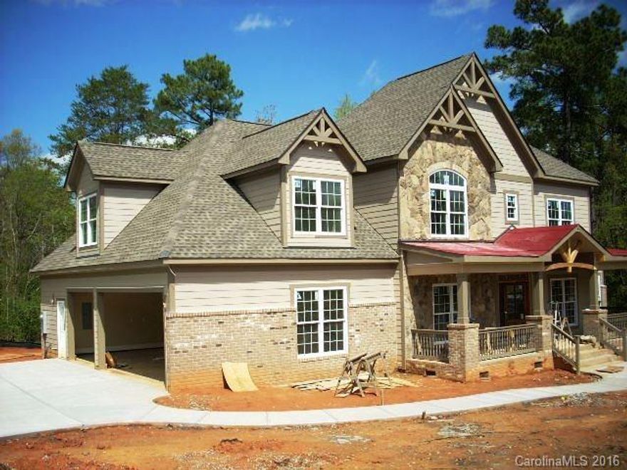 Open plan custom spec from quality builder Bill Denton. Choose hardwood and carpet colors. Stainless and granite kitchen with double oven and electric cooktop. Nice cubby by laundry. Formal dining, office or formal living, massive stone fireplace, master suite on main level. Large bonus room plus rec room up. 3 car garage in gate community. Walk 100 yards to pool and clubhouse on Lake Wylie. HOA has boat slips for lease.