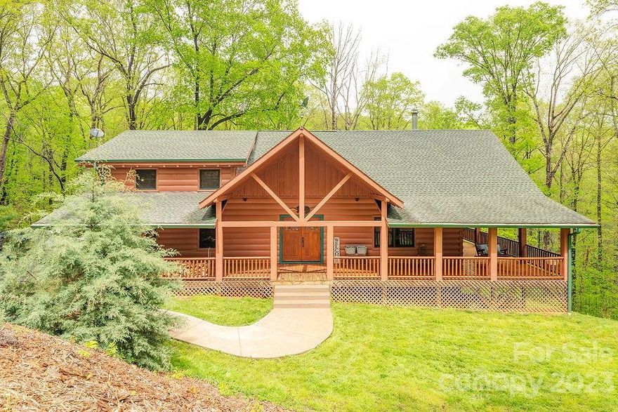 Only 15 minutes from Lake James, this gorgeous home, situated on a quiet cul-de-sac, sits on almost three acres of a private, wooded lot.  The vaulted beam ceilings and open floor plan create a grand living space.  The knotty pine walls and beams, floor to ceiling stone fireplace, and giant wrap around deck invite you to cozy up and relax, no matter the season.  Entertain in the spacious kitchen with ample counter space and storage.  Enjoy the ease of main level laundry and a lovely en suite primary bedroom.  The open loft is perfect for an office or reading nook.  Relax in the lower level hot tub, taking in the peaceful surroundings.  And the home just keeps on going with an extraordinary finished basement!   Equipped with a private entrance, the second living quarters are ready to rent out, or let visitors enjoy their own private space.  Home has been cleared of most furniture since photos, but dining set remains and is negotiable.
