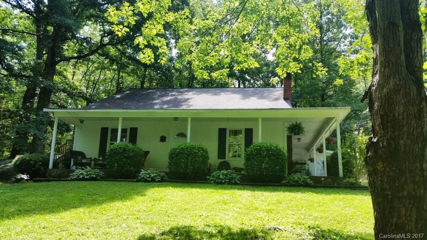 Just like living in the mountains.  Private wooded lot - approx 1.82 acres (per tax record). Fantastic home with 3 bedrooms, two full baths, master down, large eat-in kitchen, also bar/table for extra seating area, family room, extra room upstairs great for office/playroom/storage, loft/sitting area upstairs too. Wrap around porch across the front and one side of the house. Some updating has been done. Listed below tax value.  S/f per tax record.  Buyer to verify schools.  Call for appointment.