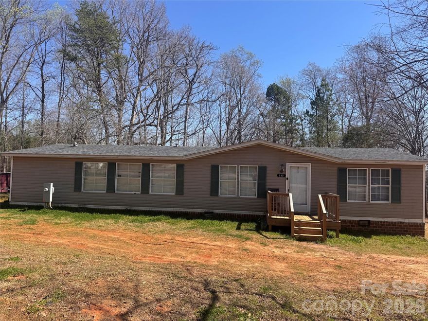 Very nice modular with 3 bedrooms and 2 baths but septic is for a 2 bedroom system. Cleared lot in a great location with Mooresville schools sitting on almost 3 acres of land. Great spot for a new build or 2- home sites.