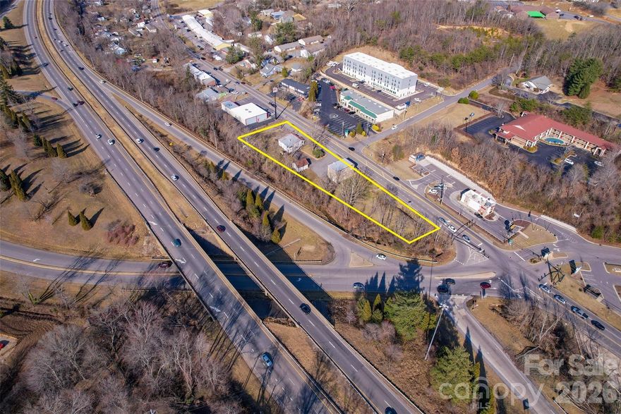 Five-level parcels totaling 1.12 acres at Exit 23 off I-26 in N. Asheville near Reynolds Mountain Village and UNC-Asheville. Outstanding visibility from I-26 (52,500 avg. daily traffic count per NCDOT). Zoned commercial shopping district which allows for restaurant, retail, gas station, office, etc. Local municipality/planner (Town of Woodfin) is easy to work with. Small part of the west side of property is in floodway. Call listing broker for more info on what can be done on the site. No survey available.
