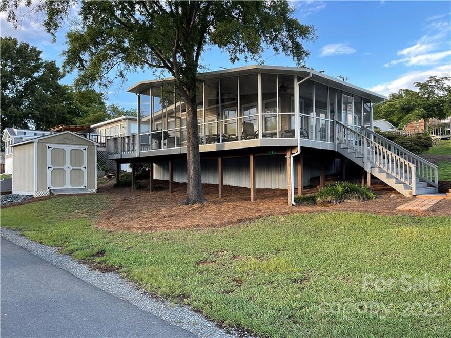 Beautiful 2 bedroom Park Model Home with full length Room addition located across the street from lake in the gated community of Badin Shores Resort & located on a double lot. (Owner only pays one HOA lot due) Park Model has one bedroom, one bathroom with large kitchen area, the room addition has nice open den area with large second bedroom. The property has a large screened in porch with an additional open deck that both offers a view of the water, storage building  & lots of room for parking. This one will go fast! The resort has lake access (boat ramp & temporary day docking, max hour limits), swimming pool, marina, sandy beach & swim area, play grounds, restaurant, putt putt, basketball courts, sand volley ball court, horse shoe pits, clubhouse and all paved private roads within the resort. Buyers of this property will have the first option to purchase the 28Ft Boat slip for an additional price. (will not be sold separately until after property is sold)