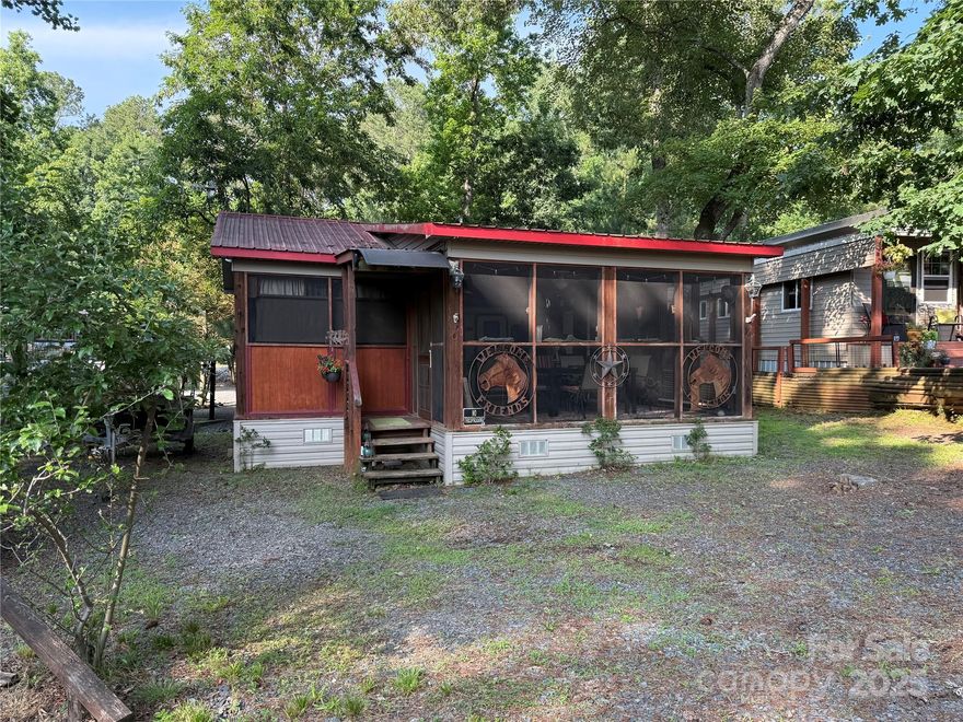 Welcome to a fabulous deck with great shade trees. Double lots for plenty of parking for all your lake toys. This well maintain 1995 30' Dutchmen is ready for you to come enjoy. Front end kitchen always give additional space, wall mounted propane heater, newer flooring and refrigerator inside. Big refrigerator on Porch. Nice sitting area, bar area and dining area all on this oversized covered front porch. Owner has installed a cut off switch for the 12v lights. real potty, small outbuilding with enclosed lean to. Most furnishings to remain. All clients must be with a realtor to gain access to the community.