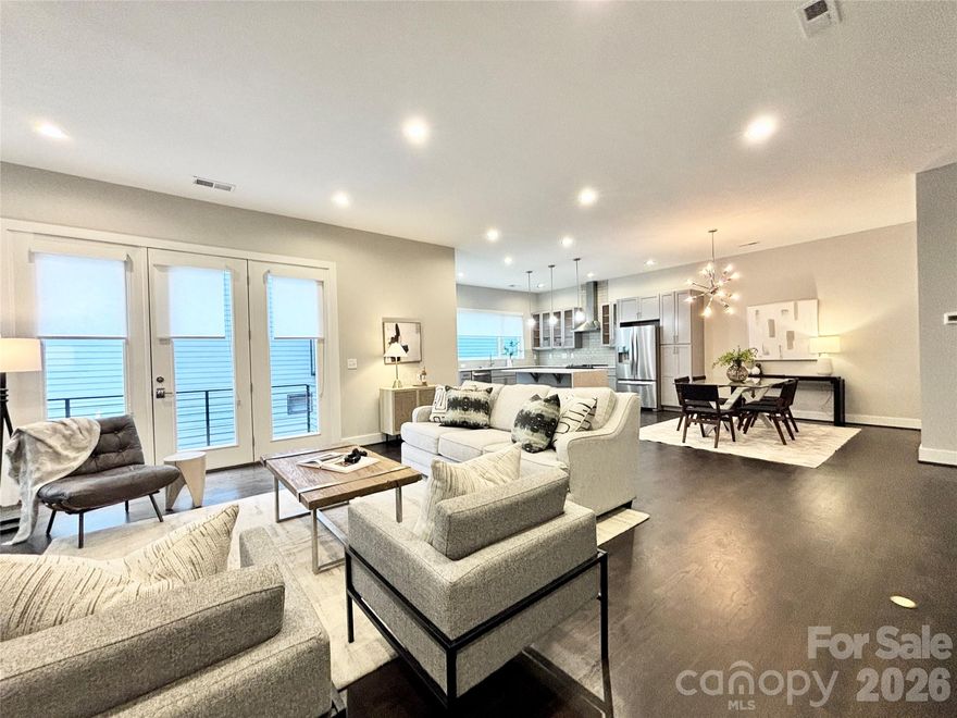 Ultimate Uptown living at its finest at Luxity Terraces in Charlotte’s highly desirable Third Ward. This move-in-ready private END residence features 3 spacious bedrooms, 3 full bathrooms, lovely powder room, and a private two-car garage — a rare Uptown advantage. The home’s hardwood floors flow seamlessly through the kitchen, living, dining, and hallways, while 10-foot ceilings enhance the open, light-filled layout. The kitchen and full baths are appointed with quartz countertops, custom cabinetry, and stainless steel appliances, combining sophistication and functionality, and full baths feature tiled floors and showers with the powder room accented in warm hardwood. A private rooftop terrace provides sweeping Uptown skyline views, offering the perfect setting for entertaining or relaxing above the city. Expansive windows frame serene views of Frazier Park, creating a rare sense of privacy and tranquility in the heart of the city. Just steps from Charlotte’s premier dining, cultural attractions, and professional sports venues, this home delivers the ideal balance of vibrant city life and peaceful retreat. With its exceptional finishes, thoughtful design, generous scale, and unbeatable location, opportunities like this are rare — a home that offers both elevated lifestyle and enduring value. Homes of this caliber attract immediate attention; act now to secure one of Uptown’s most remarkable residences. FRESHLY PAINTED INTERIOR 2026. Water and sewer included