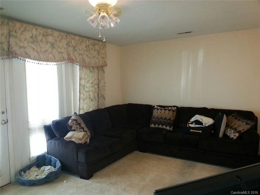 SECURED & SPACIOUS 2BR 2BA CONDO UNIT ON 1ST FLOOR! RECENTLY PAINTED & FEATURES A LARGE GREAT ROOM/DINING AREA COMBO; KITCHEN WITH BREAKFAST BAR OPEN TO GREAT ROOM; LARGE MASTER BEDROOM & WALK-IN CLOSET; CUSTOM DRAPES IN GREAT ROOM & MASTER BEDROOM; LARGE LAUNDRY ROOM; AND ADDITIONAL LOCKED STORAGE SPACE AT THE COVERED SIDE PORCH.  PRICED VERY LOW & BEING SOLD "AS IS". SELLER WILL NOT DO ANY REPAIRS.