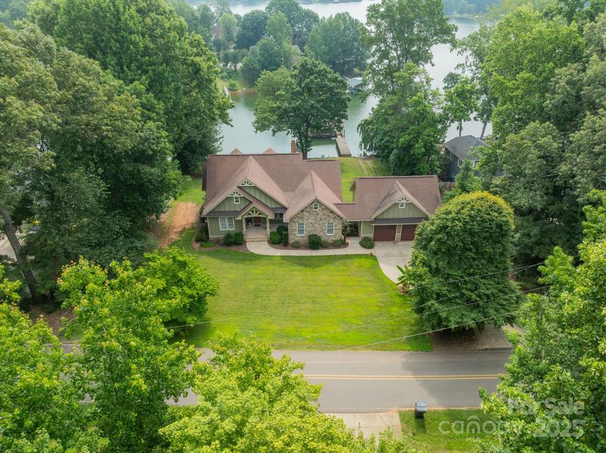 New, improved price! Stunning, personal, customized home design with 8-foot doors on both levels, rounded wall corners, beautiful site-finished wood floors, Anderson windows, 2 cozy wood-burning fireplaces. Very well-built home!  Every bedroom has a bathroom, plus there is a separate half bath conveniently located for when you come in from your lake activities. Location for elevator was built in. Large, bright kitchen + walk-in pantry make cooking and entertaining enjoyable. The spacious laundry room on the main level almost makes you want to do laundry!  There is also a second laundry hookup in the lower level.  The high-ceilinged daylight / walk-out basement could also serve well as 2nd living quarters (if a few minor modifications were made). It also has large unfinished areas for crafts, wine cellar, fitness area, seasonal items and much more. Marvelously deep lake water here makes boating and swimming very enjoyable. Delicious well water! This is located in a beautiful area with No HOA, No HOA dues! Oversized 2-car garage on main through breezeway, PLUS rear-entry garage on lower level, PLUS the walk-up over the garage is floored and drywalled, which makes for a fabulous storage or extra non-heated room. You can access all 3 levels of the garage with full-size interior staircases.  If you wanted to make the room on the upper level of the garage more of a game room away from the main house, you could add a mini-split.  Fantastic COVERED DOCK.  There is also a coveted private boat ramp - I say coveted because you can't add one to a property, and boy, do people love having one! You will probably want to do some painting and replace the carpet in the primary bedroom; seller believes you would rather pick your own colors, and you might want matching wood floor instead of carpet (quotes on-hand from the company who did the original floors and can create a gorgeous match!) The house was temporarily off the market on for about 50 days, strictly for personal reasons.