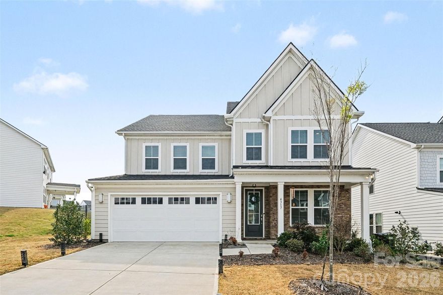 Welcome to this beautifully crafted home in the desirable Ridgecrest community, where modern design meets everyday comfort. This spacious two-story residence offers an abundance of thoughtfully designed living space with five bedrooms and four full bathrooms, providing both flexibility and room to grow.
From the moment you arrive, the home’s charming exterior with stone accents and a welcoming front porch sets the tone. Inside, you’re greeted by a bright, open layout with wide-plank flooring and abundant natural light flowing throughout. The main living area centers around a cozy fireplace and seamlessly connects to a stunning kitchen featuring an island, sleek finishes, and ample workspace—perfect for both entertaining and everyday living. A dedicated office and a main-level guest suite add convenience and versatility.
Upstairs, the spacious primary suite offers a relaxing retreat with a en-suite bathroom, complete with a soaking tub, separate glass-enclosed shower, and dual vanities. Additional bedrooms are generously sized, and the upper-level loft area provides ample flex space. The laundry room is also conveniently located upstairs for added ease.
Step outside to enjoy a screened-in patio overlooking the backyard—perfect for outdoor dining, play, or simply unwinding. The yard offers plenty of room to customize your ideal outdoor oasis.
Located in the heart of Indian Land, you’re just minutes from Ballantyne, offering easy access to shopping, dining, and entertainment, as well as convenient commuting options into Charlotte.
This home combines functional design and a wonderful location—offering the perfect blend of comfort, style, and convenience.