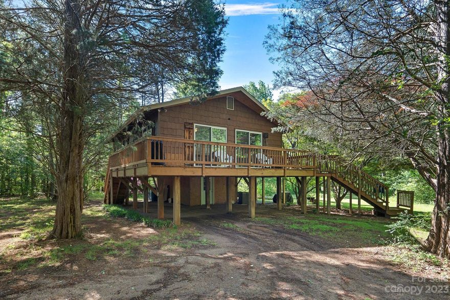 No HOA and USDA eligible for 0% down! Southern living at its best, with a wrap-around porch for your swing and rocking chairs! 2.03 acres of flat land. 2 bedrooms and 1 bath. Updates include: Upgraded kitchen counters, upgraded tile bathroom, and walk in closet in primary bedroom. LVP flooring throughout. New light fixtures and fans. The partially-finished basement has exterior access. The basement is roughly 12X24 Feet and offers heating and cooling! Plumbing has been added for a future half bath. Only a short drive to Downtown Davidson, Mooresville, Concord, and 30 min to Charlotte. Truly a must see! ZONED AO WHICH IS AGRICULTURAL/OPEN SPACE.