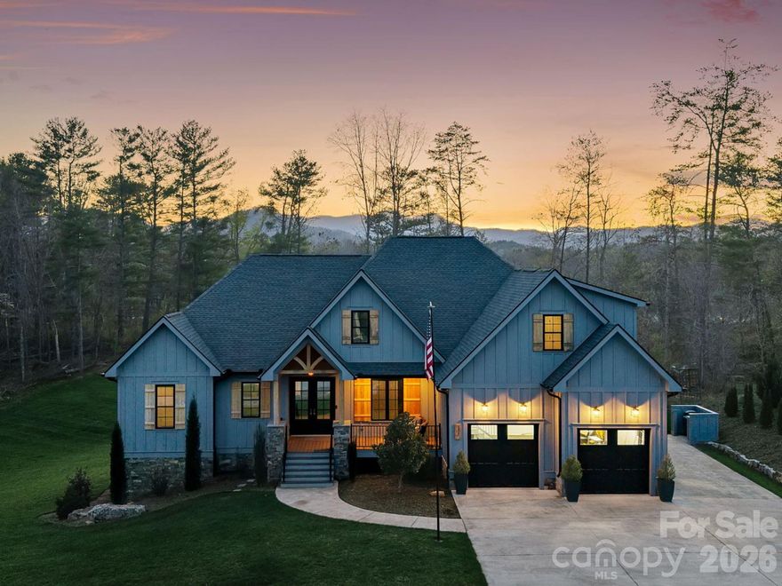 Tucked at the end of a cul-de-sac within an upscale gated community, this exceptional Arts & Crafts home is set on an expansive lot of over an acre and captures the essence of luxury mountain living, with breathtaking mountain views complemented by enchanting sunrises and sunsets, creating a setting that feels anything but ordinary.

Built in 2021 with a focus on quality and longevity, every detail reflects thoughtful craftsmanship and a commitment to elevated living. Spanning over 3,100 square feet, the design offers easy one-level living with a well-executed split-bedroom plan and an open main living area that feels both spacious and inviting. Natural light fills the home, while mirrored and tinted front windows provide privacy, complemented by tinted rear windows

The great room is anchored by a floor-to-ceiling stone fireplace and flows seamlessly into a beautifully appointed kitchen designed to impress. Custom cabinetry is abundant, featuring integrated pull-out drawers and cabinets for maximum functionality. Quartz countertops, a spacious island, and a hidden butler’s pantry with a butcher block counter create a refined and highly functional culinary space.

The main level includes three bedrooms, highlighted by a primary suite with a spa-inspired bath featuring a freestanding soaking tub, walk-in shower, and dual vanities. The walk-in closet connects directly to both the bathroom and the laundry room, a well-designed feature that enhances everyday living.
A finished upper-level suite offers a second private primary retreat, ideal for guests or multi-generational living.

The oversized two-car garage provides ample space for vehicles and storage, while a dual fuel heating system ensures efficiency and year-round comfort. An unfinished basement with 10-foot ceilings, already plumbed for a bathroom, creates exceptional potential for future expansion.

Outdoor living is thoughtfully designed with Trex decking on both the front and rear decks, with the rear deck perfectly positioned to take in the mountain views. The setting invites frequent visits from wildlife, including deer and turkeys. 
The community offers a pool, playground, picnic area, and sports courts, adding to the lifestyle and appeal of this exceptional property.

This home delivers a refined balance of modern design, intentional functionality, and a truly special mountain setting—all within easy reach of Asheville and the best of Western North Carolina.