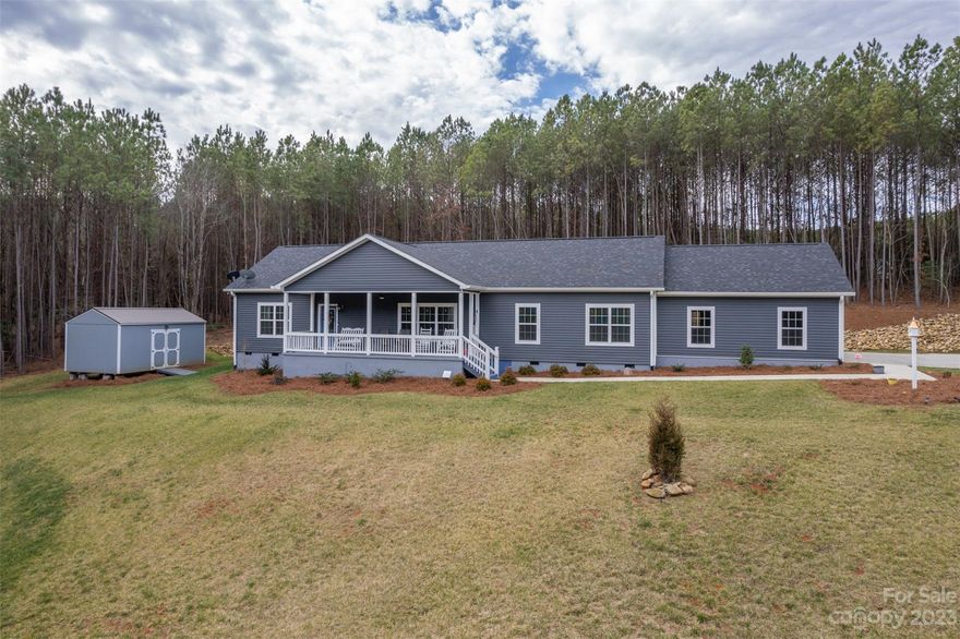 Beautiful home built in 2021, nestled on 4.53 picturesque acres! Approaching this home is an experience in itself, as a 500ft paved driveway winds through the natural beauty that surrounds the property. As you arrive, the allure of custom landscaping becomes apparent. The exterior aesthetic sets the stage for the beauty that awaits inside. 
Boasting over 1900 sq. ft. of thoughtfully designed living space, you'll find 3 bedrooms, 2 full baths, and a bonus room being used as a home office. The kitchen seamlessly connects the living spaces and is designed for both functionality and style. With ample countertop and cabinet space, meal prep and entertaining will be a breeze. Also included is a generator, storage building, and a playground with rubber mulch. Whether you're enjoying a quiet morning coffee on the front porch, hosting a gathering with friends and family, or simply taking in the beauty of the surroundings, this property offers the perfect backdrop for making lasting memories.