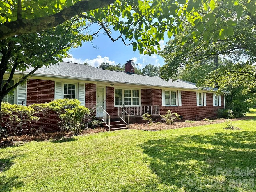 This beautiful brick residence, built in 1957, offers a spacious and inviting layout with three bedrooms and two baths. The home features a two-car garage providing convenience and ample storage. Step outside to a fully fenced back yard, perfect for outdoor activities, gardening, or secure play area. This property also has a well and county water.  Well-maintained and full of character, this classic home combines timeless design with modern functionality. Don't miss the opportunity to make this lovely property your new home.