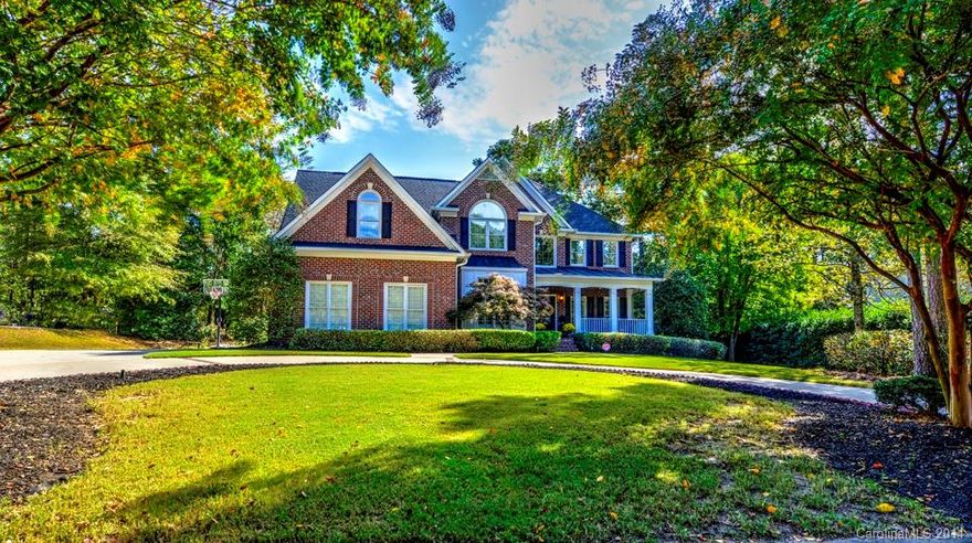 Stunning former John Wieland Model Home! Prepare to be impressed from the moment you drive up to the circular drive. Upgrades galore include wrought iron staircase, gorgeous stacked stone fireplace in two story great room, custom built ins, heavy moldings & more. Dramatic, soaring vaulted ceilings. Perfect house for entertaining with great flow! Oversized screened porch faces out to enormous, level & very private backyard. Downstairs office could double as bedroom. Huge bonus room off of master.