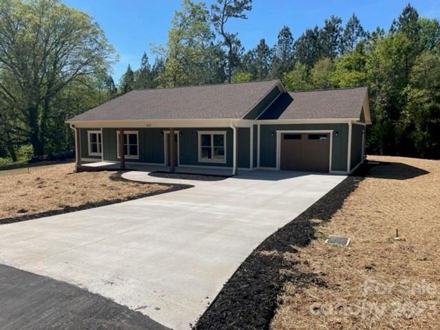 Location, Location, Location. This newly constructed home in Forest City is located close to Main Street Forest City and the Thermal Rail Trail. This is a well built 3BR 2BA  home with some very nice upscale finishes. The spacious living room has a fireplace with natural gas logs, great for those cool nights. The kitchen includes stainless appliances and granite countertops. The primary bedroom has a walk in closet and ensuite bathroom with dual vanities, custom tub and tiled shower. The home has large windows to let in lots of light and LVP flooring throughout the house. Outside there is a large front porch for sitting in a rocking chair and enjoying the peace and quiet. The 24x12 patio can be accessed from the kitchen or the laundry room. Schedule your showing soon. This one won't last long.