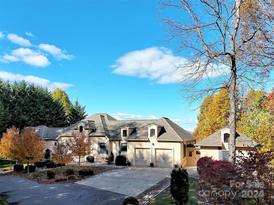 One level living, easy year round access & sweeping mountain views!  Designed with both luxury & convenience in mind, this residence offers a seamless floor plan & refined details throughout.  3 bdrms, 2.5 baths, soaring ceiling in great room, gas fireplace, kitchen with granite, Thermador & Subzero appliances, large walk-in pantry, open dining area to kitchen & sitting area.  Walk thru a breezeway to a separate office/bedroom with full bath & a basement area for additional storage or workout space.  Addition has a workshop area or small golf cart garage of 183 sq. ft. This home combines elegance & privacy with all the comforts of single-level living.   Enjoy a serene lifestyle in this stately home, nestled in a private, picturesque setting with breathtaking mountain views.