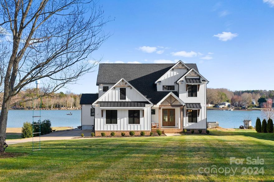 This stunning modern farmhouse built in 2020 is situated on a .69-acre lot offering incredible waterfront living. The custom-designed home features a stunning main level primary suite offering breathtaking lake views from every room. Upon entry, you'll find a private office, secondary guest/in-law suite with private entry, an open floorplan & incredible chef's kitchen. Upstairs, you'll find two additional bedrooms & two large bonus rooms. Additional upgrades include: tankless water heater, designer lighting & finishes, full-house filtration system, upgraded HVAC system, soundproofed walls and surround sound inside & out. While the pool is currently under construction, you'll get a credit to fully complete the pool and the opportunity to customize it as you wish! The lake house is conveniently located near the best restaurants, shops, schools and offers very easy access to the freeway. The incredible waterfront location has no HOA restrictions!