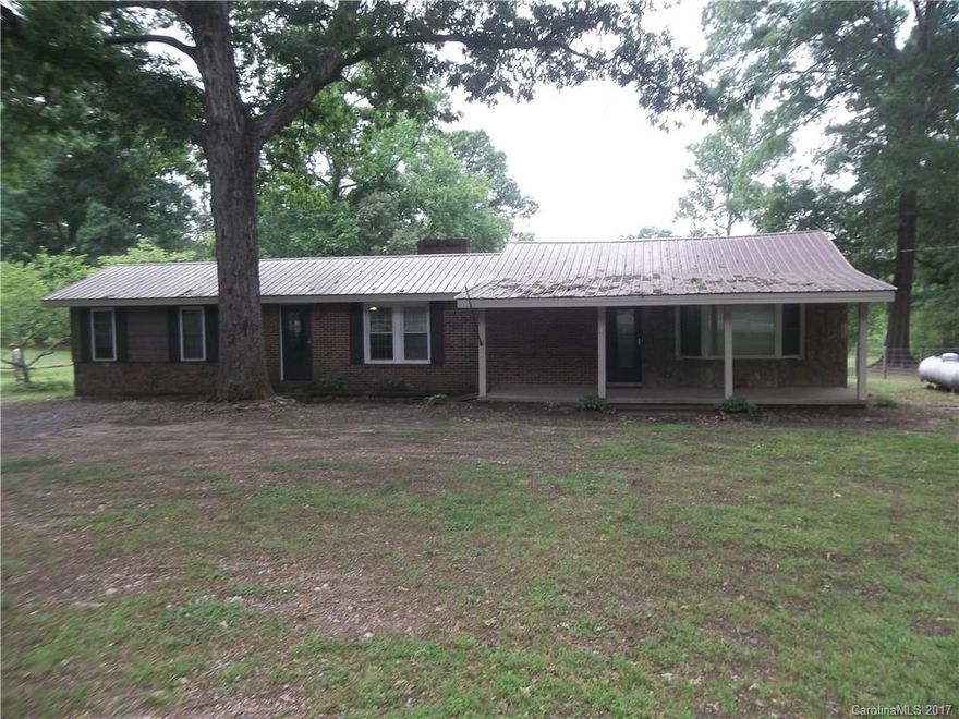 A quite country setting with a beautiful home on approximately 1 acre.  It has a spacious kitchen and dining room that is open to the living room.  The dining area has a stone fireplace.  It has 2 bedrooms.  The large bedroom has a walk-in closet and French doors that open onto the patio.  It has huge laundry room that is equipped with washer/dryer, sink, small shower, and an extra built-in oven.   The laundry room opens onto a patio at the back of the house.