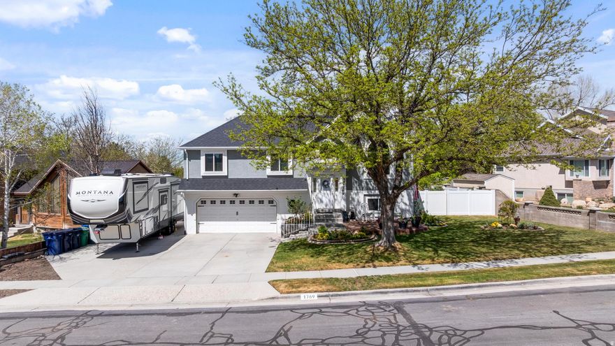 Tucked into one of Sandy's most sought-after neighborhoods, this beautifully updated home offers the perfect blend of comfort, style, and unmatched outdoor access backing directly to Dimple Dell Regional Park, one of the area's most beloved trail systems.  Step inside to an inviting, light-filled main living space with vaulted ceilings, warm hardwood floors, and an open-concept layout designed for both everyday living and entertaining. The kitchen is the heart of the home, featuring crisp white cabinetry, stainless steel appliances, and a spacious island that flows seamlessly into the dining and living areas.  Large windows frame stunning mountain views and bring the outdoors in, while the cozy living room with fireplace and custom shelving creates the perfect space to relax.  Enjoy a beautifully maintained yard with mature trees, a charming front patio, and  private access to Dimple Dell Park right down the street, offering miles of walking, biking, and equestrian trails right from your backyard. Whether you're heading out for a morning run, an evening walk, or simply taking in the Wasatch Mountain views, this location is hard to beat.  Situated on a quiet street with quick access to top-rated schools, shopping, dining, and canyon recreation, this home delivers both convenience and lifestyle.