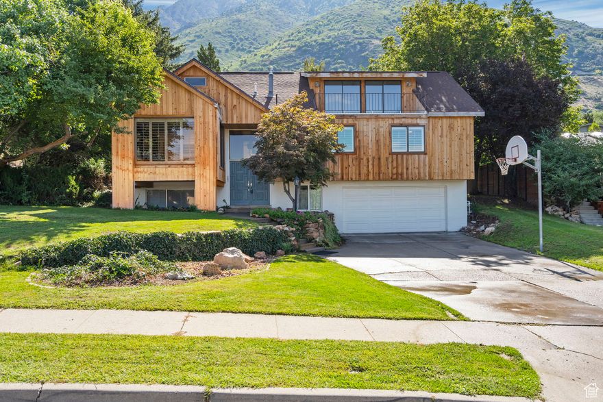 Prime location with breathtaking city and Mount Olympus views! This stunning 5-bedroom home is tucked away on a quiet cul-de-sac in one of the area's most desirable neighborhoods. Expansive windows and a spacious balcony showcase panoramic views and fill the home with natural light. The custom chef's kitchen is a true showstopper, featuring a high-end WOLF range, soft-close cabinetry, and glass doors that seamlessly connect the indoor and outdoor living spaces-perfect for entertaining. Vaulted ceilings and custom hardwood floors add warmth and sophistication, while the luxurious primary suite offers generous storage and serene comfort. A dedicated gym with skyline views and a versatile bonus room provide the flexibility to suit your lifestyle. The basement family room offers the potential to be used as an additional bedroom, office, or guest suite depending on your needs. Outside, the private backyard retreat is framed by mature pine and fruit trees, offering a peaceful escape at the end of the day. This is a rare opportunity to own a home that combines thoughtful design, high-end finishes, and unbeatable views-all in a location that supports an active and connected lifestyle. Come experience it for yourself!  Square footage figures are provided as a courtesy estimate only and were obtained from county records. Buyer is advised to obtain an independent measurement.