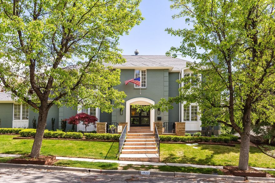 Stately two-story home located in Federal Heights, one of Salt Lake's most prestigious neighborhoods. An impressive entry welcomes you with glass front doors and a beautifully redesigned staircase. Recently remodeled in 2024, this home is in meticulous condition and showcases high-end finishes throughout. The spacious living room flows seamlessly into the well-appointed kitchen and main floor family room, with a formal dining room completing the exceptional floor plan. The living room mantle was professionally designed and custom-built for the home, perfectly complementing its style. The redesigned kitchen is a true showpiece, featuring a new island with a stunning marble waterfall countertop, quartz surfaces, a new sink and fixtures, and a stylish tile backsplash. Top-of-the-line appliances include a 48-inch Sub-Zero refrigerator/freezer, 48-inch Wolf range, Cove dishwasher, Sub-Zero wine refrigerator, and Sub-Zero beverage refrigerator. The mudroom has been thoughtfully updated with new cabinetry and a built-in bench. The kitchen's dining area flows seamlessly into the main-level family room, highlighted by stone floors and a dramatic fireplace. A bonus playroom with custom built-ins completes the main floor. Hardwood floors have been refinished on the main level, with new hardwood installed on the staircase and throughout the upper level, except in the tiled bathrooms. Upstairs, the primary suite offers dual closets and a spacious bathroom with double vanities, a separate tub and shower, heated floors, and a private office with its own fireplace. A bright and airy workout room adjoins the primary bedroom. Two additional bedrooms include one en-suite, plus a third bedroom with a separate bathroom. The lower level features above-grade windows, new carpet, a large family/playroom, a laundry room with new tile and cabinetry, a guest bedroom, and a newly remodeled bathroom. The front and backyard have been completely reimagined with new professional landscaping, garden beds, sprinklers, and fencing.  An attached two car garage adds the finishing touch to this exceptional home.