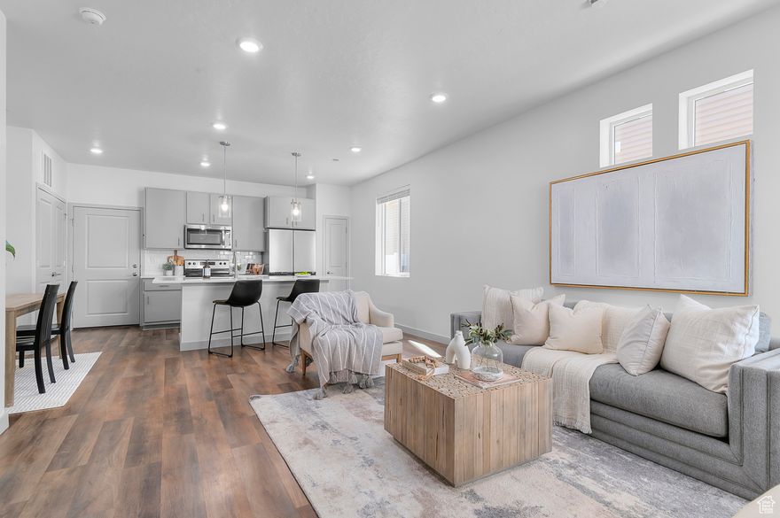 Experience modern comfort and low-maintenance living in this stunning 4-bedroom, 2.5-bath twin home featuring a bright, open-concept design. The spacious great room welcomes you with oversized windows that fill the space with natural light and create a warm, inviting atmosphere.  The kitchen is truly the heart of the home, complete with a large eat-in island, stylish quartz countertops, stainless-steel sink, generous pantry, and all appliances included. Perfect for gathering and entertaining, the flow between the kitchen, dining, and living spaces makes everyday living effortless.  Upstairs, the primary suite offers a peaceful retreat with a spacious walk-in closet and a private bath. Three additional bedrooms provide plenty of room for family, guests, or a home office.  Previously rented for $2200/mo.    The home also includes a 2-car insulated garage and a beautifully designed exterior that complements the low-maintenance lifestyle.  Located along Utah Lake's scenic north shore, this amenity-rich community offers acres of parks, trails, and recreational opportunities - all just steps from your door.  Come discover the perfect blend of style, comfort, and convenience in this exceptional home.  **Square footage figures are provided as a a courtesy estimate only. Buyer is advised to obtain an independent measurement.**