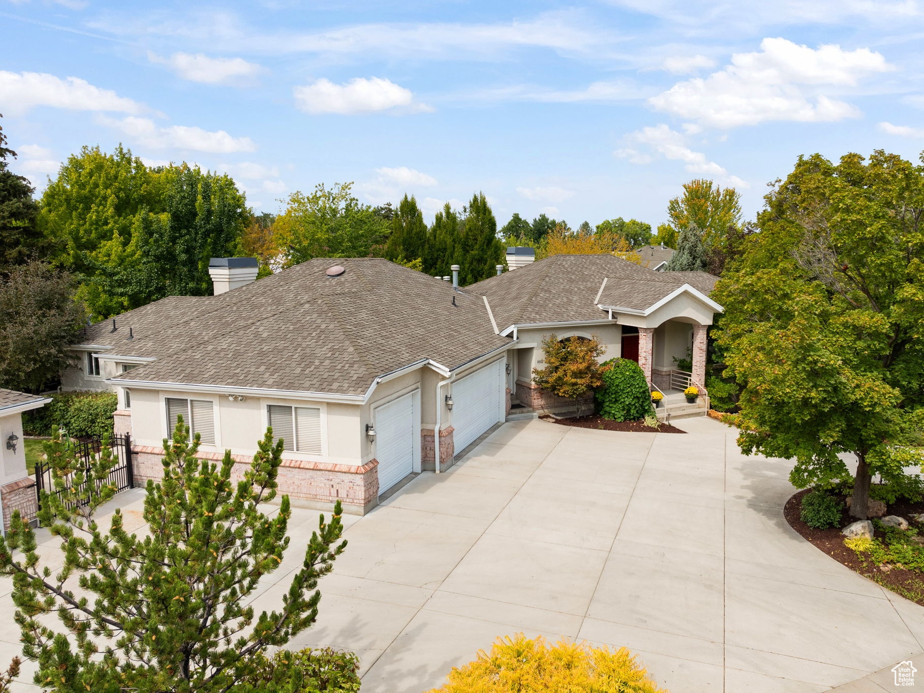 Welcome to this beautiful 6-bedroom home in Sandy, situated on a spacious lot with mature landscaping and a large circular driveway. The property features an additional detached garage complete with a lift, perfect for car enthusiasts or extra storage. The main level offers a generous layout with the primary suite conveniently located on the main floor. The ensuite has been tastefully updated with new laminate flooring and includes dual vanities, a walk-in shower, a large soaking tub, and dual walk-in closets. The kitchen is a chef's delight, featuring high-end appliances including a gas range, and opens to comfortable living and dining spaces. The walkout basement is designed for both relaxation and entertainment, complete with a full wet bar, an additional living area, and a large recreation space that could serve as a home gym, office, or game room. A second laundry room on the lower level adds convenience and functionality. Outdoor living is just as inviting, with two pergola-covered decks, a custom paver patio, and a private backyard retreat surrounded by mature trees. This home is ideally located in a quiet Sandy neighborhood, just minutes from Dimple Dell Regional Park, Little Cottonwood Canyon, world-class ski resorts, hiking and biking trails, and convenient shopping and dining. With its thoughtful design, prime location, and unique amenities, this property is the perfect place to call home. Square footage figures are provided as a courtesy estimate only and were obtained from county records. Buyer is advised to obtain an independent measurement.