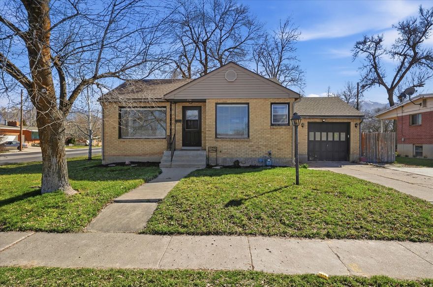 Charming brick rambler on a corner lot in Logan featuring hardwood floors, mature trees, and a spacious backyard. The main level offers a bright living area, two bedrooms, and a functional kitchen with subway tile backsplash and painted cabinetry. Fully finished basement includes additional bedroom, family room, large laundry area, and second kitchen setup-offering potential for a mother-in-law apartment or separate living space. Enjoy the fenced yard, covered patio, and unique treehouse. Conveniently located near schools, parks, and Logan amenities.