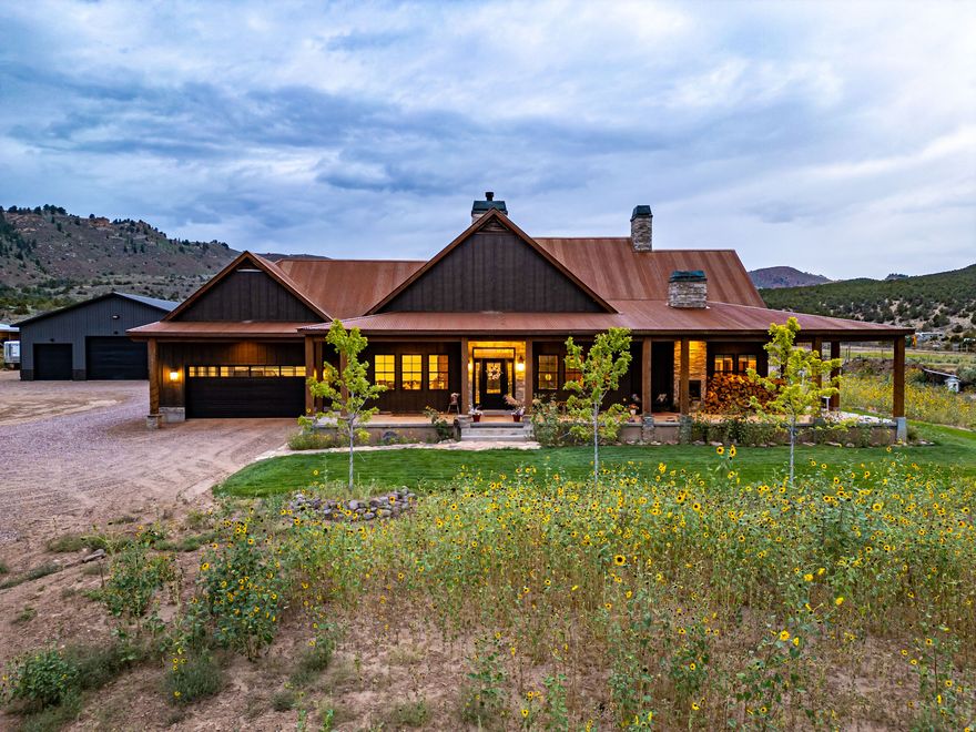 Welcome to the iconic Wolf-Raven Ridge. Inspired by the timeless architecture of Jackson Hole, this Dry Fork Canyon estate is more than a home-it's an experience. From the moment you enter Dry Fork Canyon, there's a sense you've arrived somewhere extraordinary, where mountain air mixes with the scent of pine and the views open wide to the Sawtooth backdrop with wilderness stretching out in every direction, surrounded by the vastness of National Forest and BLM lands. Set on over eight acres, the property blends privacy and freedom with a level of craftsmanship and detail that can only come from a fully custom build. The approach begins at the covered porch framed by Amish-crafted timbers, and inside you're welcomed by soaring 20-foot vaulted ceilings, knotty alder beams and cabinetry, and fireplaces anchored with stones hand-selected from Ashley National Forest. Every space has been designed not just to impress but to create moments of connection and comfort, from the chef's kitchen with Sub-Zero fridge, Caf Series appliances, custom copper-trimmed hood, hidden walk-in pantry, and pine tongue and groove accents, to the subtle glow of hidden lighting and the discovery of a secret bookcase hutch. The master suite is its own retreat with a freestanding tub, steam shower, and custom built-ins, while the home's systems quietly deliver efficiency and reliability with dual heat pumps, 95%+ furnaces, tankless water, and a 1,000-gallon propane supply. Step outside to a stamped patio for evenings under the stars, a 2,000 square foot insulated shop with pass-through garage doors, and grounds that include horse facilities, gardens, and groomed walking trails. Wolf-Raven Ridge is a property that makes a statement yet feels deeply personal-crafted with integrity, rooted in vision, and set in a location that simply cannot be replicated. Nothing like it has ever been offered in the Uinta Basin, and nothing else will capture your imagination in quite the same way.
