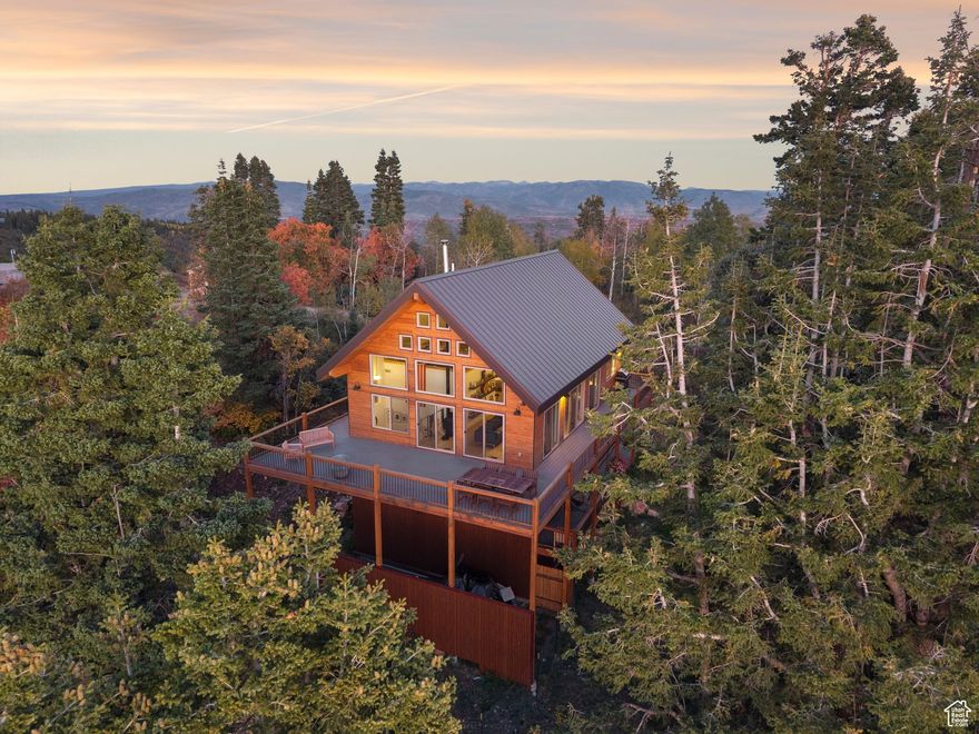Custom built in 2019 and framed by 100 year old Fir Trees, perched atop a mountain is what the locals call Skyfall. Rustic and modern living seamlessly merge to create a peaceful private retreat in this turnkey property, which was meticulously designed by the owner with no details overlooked. A once-in-a-lifetime opportunity to own 12.54 acres in the pristine Wasatch Mountains backing up to thousands of acres of open space. The property is surrounded by mature Aspen, Maple and Fir Trees with breathtaking views of every major ski resort in northern Utah, the Wasatch, Oquirrh and Uinta Mountain Ranges. Enjoy evenings spent on the expansive deck as the sunset reflects off The Great Salt Lake. Oversized windows and cathedral ceilings allow light to pour into the main living area throughout the year. The open floor plan allows for effortless indoor/outdoor living and is perfect for hosting. A cook's dream kitchen boasts bar seating for 5 people. With an oversized two car garage, large master bedroom, bath, laundry and walk in closet, guest bedroom, guest bathroom, two mudrooms, a flexible loft/bunk room/home office space, and fully finished basement, this home is the perfect gathering place, weekend getaway, or dream home for a family. After a long day of skiing or mountain biking right from your front door, enjoy the six person Sauna and cold plunge, or put your feet up and settle in by the wood burning stove. During a full moon you'll be immersed in a symphony of wildlife - coyotes, owls, and elk. Skyfall was designed to embrace the incredible landscape and atmosphere of the high alpine, all while being just 15 minutes away from the amenities of Kimball Junction.This property is a rare gem. In addition to the main residence, the generous acreage provides ample space and potential for the addition of two outbuildings, ideal for a guesthouse, workshop, or storage for recreational equipment.