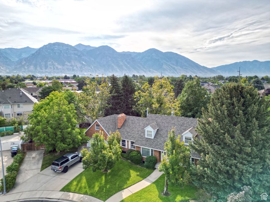 Perched on prestigious Grandview Hill in upscale Provo, this timeless brick-exterior gem boasts panoramic views of Utah Valley and the majestic Wasatch Mountains. Remodel includes new kitchen cabinets, appliances, bathroom cabinets, electrical outlets and switches, can lighting, paint,  floor coverings, new fencing. Towering mature trees provide shade and privacy around a expansive large garden, and storage sheds evoking a sense of tranquility. The spacious floor plan features large rooms that flow effortlessly, ideal for comfortable living.  The home has been remodeled and updated.  The basement includes a versatile 2-bedroom accessory apartment, perfect for guests, extended family, or rental income with outside entrance.  Large RV parking pad for storage Located near top-notch schools,  convenient shopping and freeway access.  All information is provided as a courtesy and buyers are advised to verify all information.