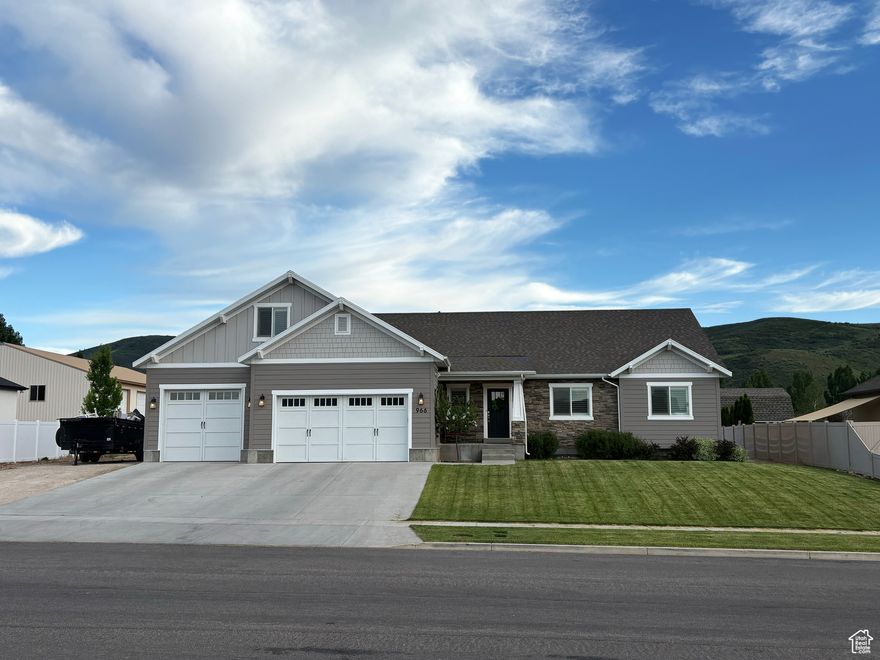 Price drop! Welcome to this custom-built family home in the highly desirable Heber Meadows neighborhood! This spacious and thoughtfully designed home features wide hallways, large bedrooms with oversized closets, and a vaulted ceiling in the primary suite. The kitchen includes beautiful granite countertops, a walk-in pantry, and flows into generous living spaces perfect for entertaining or everyday living. You'll love the energy-efficient upgrades throughout, including two Carrier wall AC units, a programmable thermostat, a water softener, and the home is piped for a wood stove. The mudroom provides practical storage and a clean transition from the outdoors. The extra-deep third bay of the 3-car garage is a standout, with 220 power, piped for a future furnace, built-in shelving, a utility sink, and hot and cold water-ideal for projects, hobbies, or extra storage. The outdoor space is equally well-equipped with flood lights, under-eave lighting, a heat coil on the porch roof to prevent ice buildup, and multiple outlets for Christmas lights. A 26-foot-wide gravel RV parking pad adds incredible versatility for vehicles, trailers, or toys. The large basement storage room with shelving completes the home, offering space for everything from seasonal dcor to food storage. This is a rare opportunity to own a well-maintained, feature-rich home. Come and see it today! Square footage figures are provided as a courtesy estimate only.