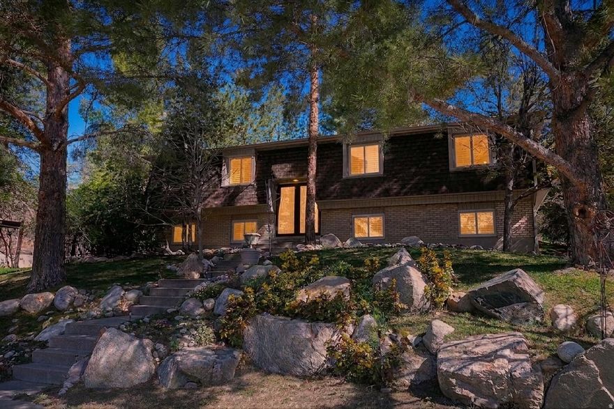 Experience mountain living at its finest in this "Chalet in the Pines!" This 2021 renovation is impeccably clean and move-in ready. The chefs kitchen boasts a quartz island and buffet, induction range, and new fridge. Relax in the spa-like primary bath featuring a rain shower or enjoy the open-concept living area with custom built-in cabinets and premium Pella windows/doors with plantation shutters. The private, resort-style backyard is a sanctuary, featuring a custom stone patio, hot tub, and local landscape boulders nestled among the pines. Located in a prime Cottonwood Heights neighborhood near both Cottonwood Canyons, this freshly painted gem offers an opportunity to own a high quality and unique home in a special community.