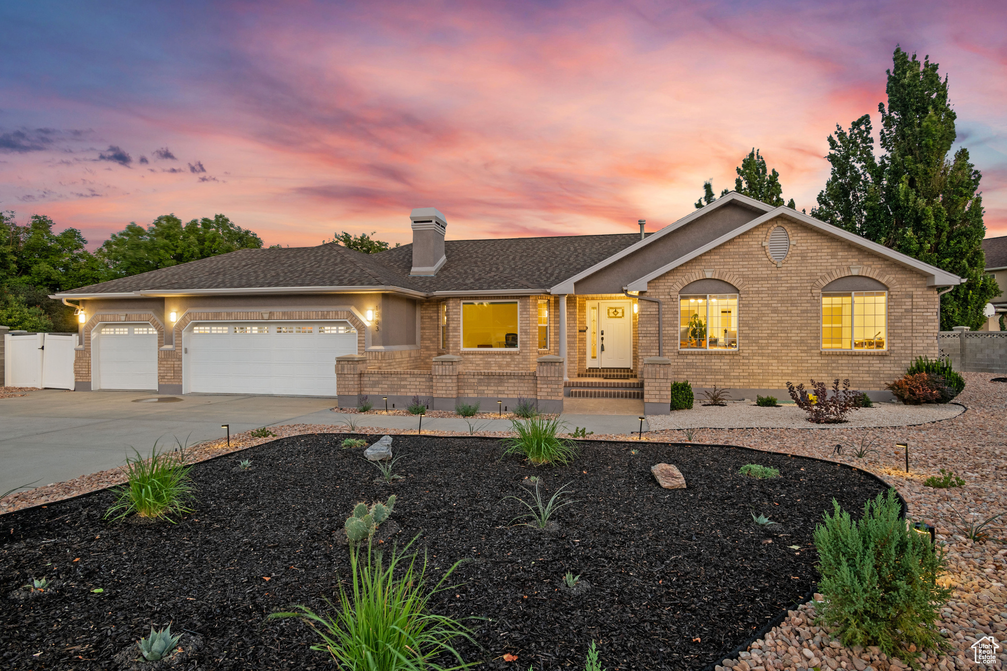Modern South Jordan Stunner with Designer Kitchen and Xeriscaped Outdoor Living! A singular modern gem in desirable area of South Jordan, this thoughtfully updated home blends design, sustainability, and comfort. Light-filled interiors feature vaulted ceilings and wide-plank flooring with elevated design details, including two marble-surround fireplaces and European doors. The chef's kitchen showcases granite counters, a large island, and Samsung Bespoke appliances (2023). The primary suite is a serene retreat with a freestanding soaking tub and dual vanities, while the reimagined laundry includes a custom dog wash. The curated xeriscaped grounds include nearly 200 drought-resistant plants with Italian porcelain pavers connecting multiple gathering areas. A three-car garage with epoxy flooring, high-clearance doors, smart openers, and an EV charger completes a home designed for effortless, practical modern living tucked away in a quiet cul-de-sac.
