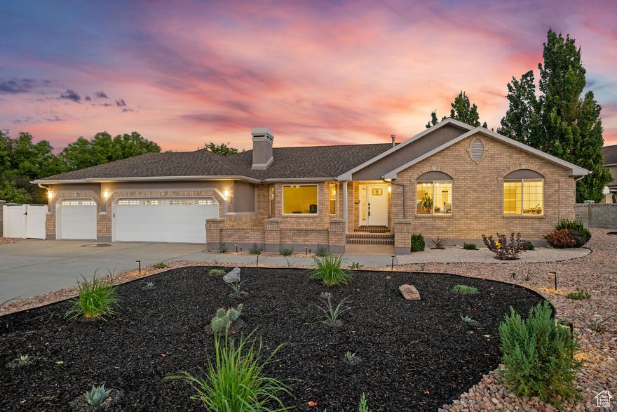 Modern South Jordan Stunner with Designer Kitchen and Xeriscaped Outdoor Living! A singular modern gem in desirable area of South Jordan, this thoughtfully updated home blends design, sustainability, and comfort. Light-filled interiors feature vaulted ceilings and wide-plank flooring with elevated design details, including two marble-surround fireplaces and European doors. The chef's kitchen showcases granite counters, a large island, and Samsung Bespoke appliances (2023). The primary suite is a serene retreat with a freestanding soaking tub and dual vanities, while the reimagined laundry includes a custom dog wash. The curated xeriscaped grounds include nearly 200 drought-resistant plants with Italian porcelain pavers connecting multiple gathering areas. A three-car garage with epoxy flooring, high-clearance doors, smart openers, and an EV charger completes a home designed for effortless, practical modern living tucked away in a quiet cul-de-sac.