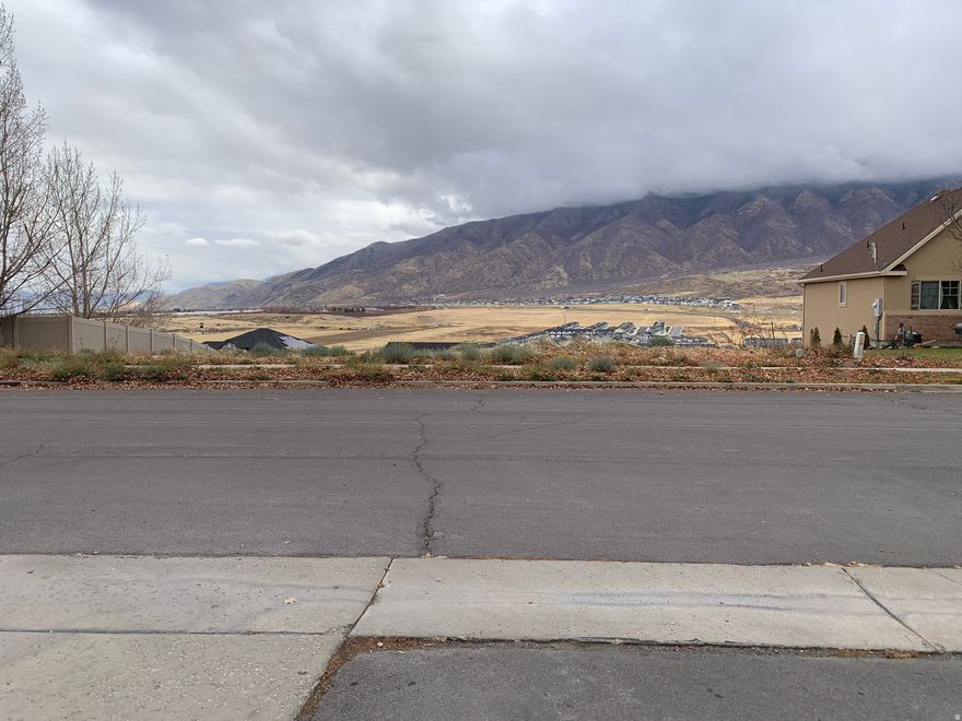 This prime building lot lies on a quarter acre and features unobstructed mountain and valley views. Potential for a walkout basement. The lot is already stubbed for water, power, and sewer. There is a soccer sports complex and a small, shallow lake to the north of the property. Take advantage of Santaquin Canyon and hiking trails in the mountains to the east. Buyer to verify all information.