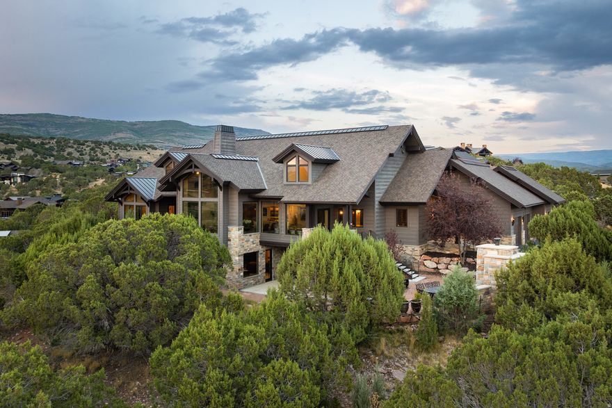 Perched within the scenic landscape of Red Ledges, this exceptional 1.29-acre estate captures sweeping views of Mt. Timpanogos and the surrounding red rock formations, all framed by mature juniper trees and native landscaping. Thoughtfully designed with an open-concept floor plan, the home offers seamless indoor-outdoor living with expansive gathering spaces and seven well-appointed en-suite bedrooms, creating an ideal setting for both entertaining and private retreat.  Every element of the home has been curated to balance refined mountain luxury with everyday comfort and functionality, resulting in a truly timeless residence suited for legacy ownership.  A full Red Ledges Golf Membership is available with deposit, providing access to the community's Jack Nicklaus Signature Golf Course and Golf Park, along with a full suite of amenities including tennis and pickleball courts, resort-style pools, multiple dining venues, a state-of-the-art fitness center, equestrian facilities, and a year-round lifestyle highlighted by a private ski program with shuttle service to Deer Valley.