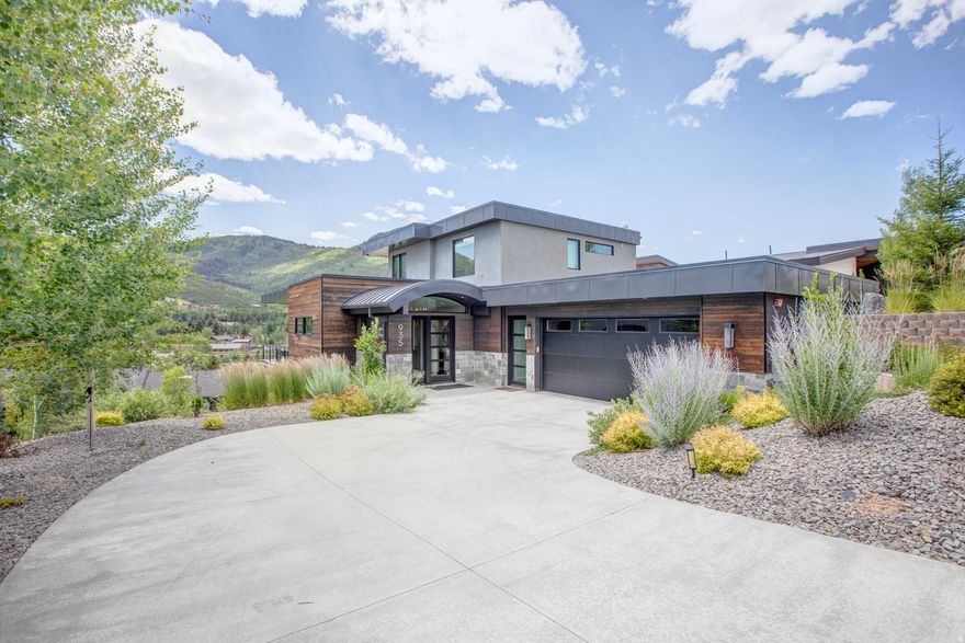 A perched sanctuary with accessibility, this location offers a rare blend of sweeping views, privacy, and proximity to it all. Enjoy this stunning, 2020 four-bed home featuring immediate mountain views from Deer Valley to Canyons Village, elevated fixtures and finishes, and modern technology. Main-level living, craftsman level fireplaces, wood floors, leathered granite & quartz countertops, custom floating furniture. Each bedroom boasts its own roomy en-suite bathroom with dual sink vanities, walk-in showers, heated floors and under-cabinet lighting. Ample built-in closets and storage throughout ... Beautiful kitchen and butler pantry. Extra-large mudroom. The primary suite and home office are up one level. A standout feature in the lower level living area is the sports den and bar. TVs are located in every bedroom, in the main living areas, and even outside by the hot tub! Music can also be streamed from your devices to the wireless speakers in the living and family rooms. Main level and lower-level wrap-around decks with fire pit, bbq and hot tub. Spacious mudroom , 2 car garage, heated driveway. Deer Valley, Park City Mountain, and Canyons Village just minutes away, along with Historic Main Street's world-class dining and entertainment. A five-minute scenic path takes you to grocery store, a liquor store, and multiple dining options. A variety of additional shopping and dining within walking distance, and the free City bus proves easy access to the rest of Park City. Whether you're relaxing by the fire, soaking in the private hot tub, or sharing a toast at the in-home bar and sports den, every moment here feels elevated.