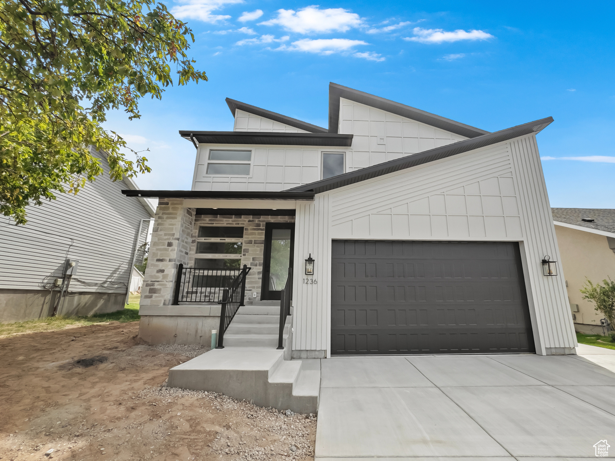 Don't miss this rare opportunity to own a designer home crafted by a Parade of Homes winner, Dalton Construction. Located in East Layton-just minutes from Highway 89 and local shopping. Showcasing a sleek modern-chic aesthetic, this home features an expansive open-concept great room and kitchen with soaring ceilings and a dramatic two-story tiled fireplace. The kitchen is a chef's dream, complete with walnut-stained flat panel cabinetry, quartz countertops, stainless steel vent hood, and an oversized butler's pantry with butcher block counters-perfect for concealing appliances and keeping your space clutter-free. Upstairs offers incredible flexibility with four spacious bedrooms, plus a bonus room with a 14 Ft. vaulted ceiling. The luxurious primary suite includes a spa-like ensuite bathroom with a freestanding soaking tub, glass-enclosed shower, private water closet, and a large walk-in closet. The upstairs laundry room adds convenience to function. The unfinished basement provides room to grow, with potential for a second kitchen/bar, additional bedroom, and bathroom-ideal for a future family or entertainment space. An oversized 24'x24' built-in garage with an 18'x 10' door is perfect for your vehicles and room for storage. A private backyard framed by mature pine trees completes this one-of-a-kind property. Schedule your showing today-this home is a must-see!