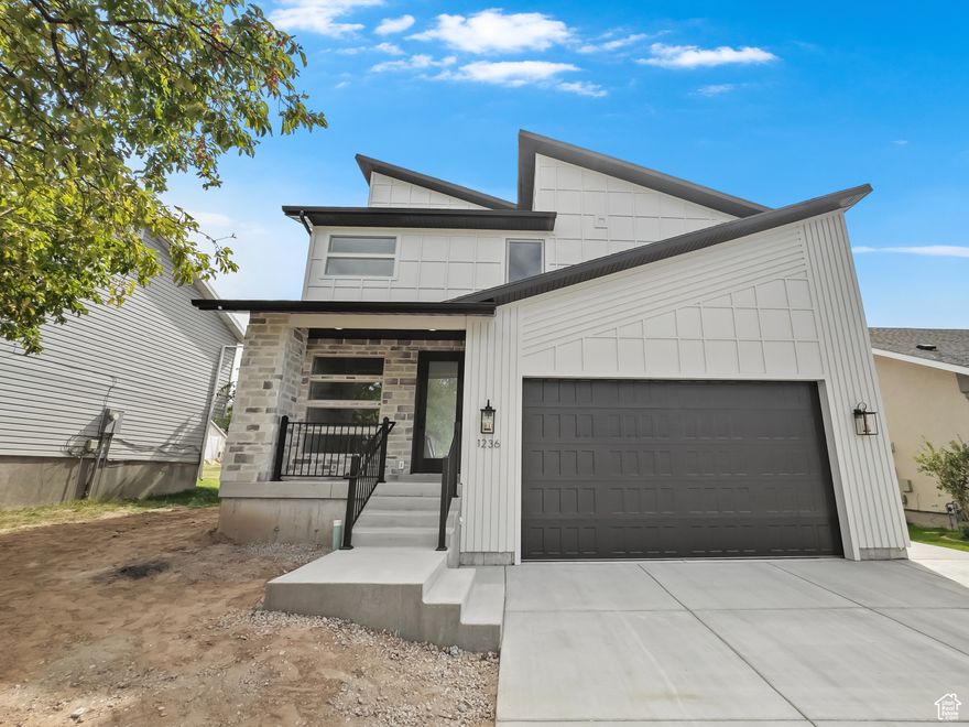 Don't miss this rare opportunity to own a designer home crafted by a Parade of Homes winner, Dalton Construction.  Located in East Layton-just minutes from Highway 89 and local shopping.  Showcasing a sleek modern-chic aesthetic, this home features an expansive open-concept great room and kitchen with soaring ceilings and a dramatic two-story tiled fireplace. The kitchen is a chef's dream, complete with walnut-stained flat panel cabinetry, quartz countertops, stainless steel vent hood, and an oversized butler's pantry with butcher block counters-perfect for concealing appliances and keeping your space clutter-free.  Upstairs offers incredible flexibility with four spacious bedrooms, plus a bonus room with a 14 Ft. vaulted ceiling.  The luxurious primary suite includes a spa-like ensuite bathroom with a freestanding soaking tub, glass-enclosed shower, private water closet, and a large walk-in closet. The upstairs laundry room adds convenience to function.  The unfinished basement provides room to grow, with potential for a second kitchen/bar, additional bedroom, and bathroom-ideal for a future family or entertainment space.  An oversized 24'x24' built-in garage with an 18'x 10' door is perfect for your vehicles and room for storage.  A private backyard framed by mature pine trees completes this one-of-a-kind property. Schedule your showing today-this home is a must-see!