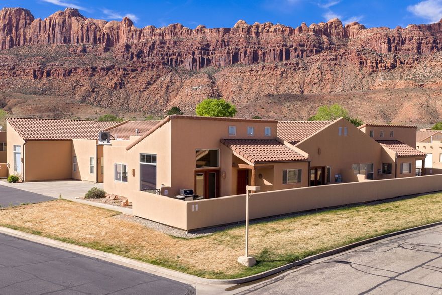 Exceptional Rim Village Unit  Nightly Rental Opportunity! Welcome to your perfect Moab retreat in Rim Village, where comfort, style, and investment potential come together seamlessly. This beautifully appointed 3-bedroom, 2-bath townhome offers an inviting layout accented by elegant slate flooring and warm, cozy touches throughout. Two gas fireplaces create the perfect ambiance, including one in the spacious primary bedroom for a private, relaxing escape. Step outside from the French doors in the primary bedroom to your own hot tub and soak in the stunning desert surroundings after a day of adventure. The home also features a convenient 2-car garage and is ideally located just a short distance from the community pool. Offered fully turnkey, this property is ready to go as a successful overnight rental with a strong rental history, making it an exceptional opportunity for both personal enjoyment and income generation in the heart of Moab. Pool and spa in the common area have been completely upgraded. The spa was enlarged in 2025.