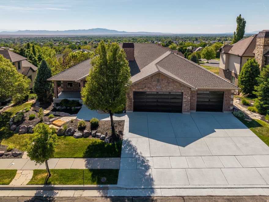 **OPEN HOUSE SAT. 5/9 11 AM - 1 PM** Who wants unobstructed views of the valley! Perched within the coveted Hidden Springs community, this exceptional residence captures truly unobstructed 360-degree mountain and valley views, offering a rare blend of refined luxury and everyday serenity. Thoughtfully positioned to embrace its breathtaking surroundings, the home invites seamless indoor-outdoor living with both a covered upper deck and expansive lower patio designed for sunset evenings and year-round entertaining. A welcoming entry introduces a beautifully appointed private office with its own direct access to the rear deck-an inspiring retreat for work, creativity, or quiet moments overlooking the landscape. The heart of the home unfolds into a light-filled great room where soaring vaulted ceilings, custom built-ins, and panoramic windows frame the surrounding scenery from nearly every angle. The open-concept kitchen and living spaces are designed for effortless gatherings, featuring a generous center island, granite countertops, beautifully white cabinetry, and a thoughtfully integrated pantry. The main-level primary suite offers a peaceful sanctuary with sweeping views and a spa-inspired bath complete with a soaking tub, separate shower, and elevated finishes that create a true retreat experience. Convenience meets functionality with laundry rooms located on both levels of the home. Downstairs, the fully finished lower level offers exceptional flexibility for entertaining and extended living. A spacious family room with kitchenette is complemented by an additional office or craft room featuring extensive wall-to-wall built-ins. Three additional bedrooms and two bathrooms provide comfortable accommodations for family and guests alike. Recent upgrades include a newly installed heating and cooling system along with a fully integrated solar system, combining modern efficiency with long-term sustainability. Outside, meticulously manicured landscaping enhances the home's striking curb appeal and tranquil atmosphere. Residents of Hidden Springs enjoy access to one of the area's most admired lifestyle communities, complete with a clubhouse, pool, fitness center, hot tub, and beautifully maintained common spaces. The Beautiful Tree-lined streets and signature neighborhood water feature create a welcoming sense of arrival. Just moments from the foothills, residents enjoy immediate access to hiking and mountain biking trails, while remaining conveniently located near shopping, dining, freeway access, Station Park, Salt Lake City International Airport, and Snowbasin Resort. Opportunities to own a view property in Hidden Springs are exceptionally limited-and highly sought after.