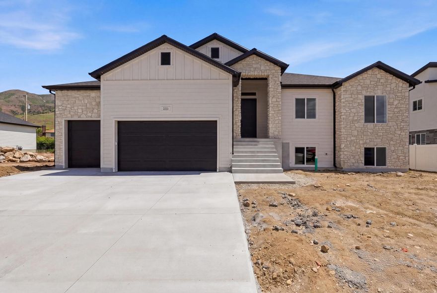 Stunning modern transitional rambler located on the east bench of Perry with breathtaking mountain and valley views. Built by a builder known for exceptional craftsmanship and high-end finishes, this home features 3 bedrooms, 2 1/2 bathrooms, a 3-car insulated garage, and an unfinished walkout basement with room to grow. The grand 12-foot entry and Great Room ceilings give it an open, inviting layout. Enjoy Beautiful custom LVP flooring, accent walls, iron stair railing, custom tile showers with Euro glass, Bosch appliances, a large island, Level 6 quartz countertops with mitered edges, and an incredible lighting package. The luxurious primary suite includes a soaker tub and large custom closet. Additional upgrades include a covered deck, tankless water heater with recirculator, 5 Ft. Linear Fireplace, 96% efficiency furnace, MyQ insulated garage doors, custom pantry shelving, and beautiful stone, Hardi, and stucco exterior. Seller is offering a $10,000 incentive toward buyer closing costs, subject to lender requirements. A rare combination of luxury, quality, and peaceful bench living.