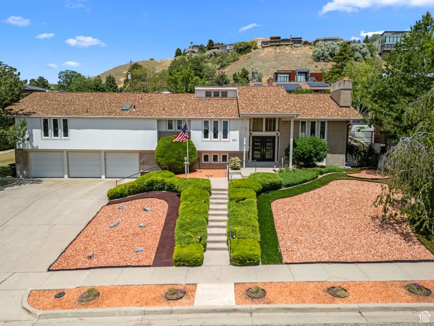 PRICE IMPROVEMENT!  Classic Mid-century modern perched high in the Avenues with sweeping mountain and valley views, superb indoor-outdoor flow, and unbeatable access to the best of Salt Lake living.  This 6 bedroom/3 bathroom gem sits just a short drive from the top schools in the Salt Lake City School District.  Love the Outdoors?  You'll be steps from the trailhead entering the Bonneville Shoreline Trail and the Foothills Natural Area--perfect for hiking, biking, or nature walks.  Inside you'll find the charm and function you've been looking for:  double ovens, plentiful storage, cozy fireplaces, (gas upstairs and wood insert downstairs)  two sliding doors to a covered patio and a fenced backyard with peach tree, grapevines, and garden plot.  The primary suite has a walk-in closet and a barrier-free walk-in shower.  A three-car garage and propane BACKUP GENERATOR for peace of mind.    All this, yet you're just a short drive to downtown, local shops and cafes and major commuter routes.  Great opportunity to own in the High Avenues--Don't miss out on this rare find.