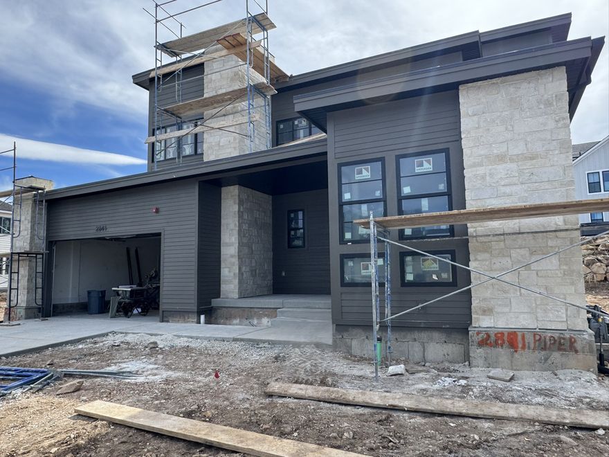 This stunning Sidewinder Modern is located in a posh Park City community with all the amenities! The home features a chef's kitchen with custom cabinetry highlighted with LED lighting, quartzite countertops, and professional-grade Monogram stainless steel gas appliances with double ovens. The open-concept kitchen is enhanced by pendant lighting over the island and seamlessly flows into the great room, complete with a gas log fireplace. Rich hardwood, tile, and carpet flooring run throughout. This home offers a finished extended garage with exit door, 10-foot basement foundation walls, finished basement space, and an expanded covered deck perfect for entertaining. Thoughtful upgrades include a humidifier, radon ventilation system, and gas line to the BBQ. The owner's suite and bathrooms feature elegant tile surrounds, complemented by black matte hardware and textured walls with 2-tone paint. Design highlights include cased windows, ceiling beam accent in the office, and French doors for added sophistication. This is a rare opportunity to own a modern retreat blending luxury, comfort, and function in one of Park City's most desirable settings.