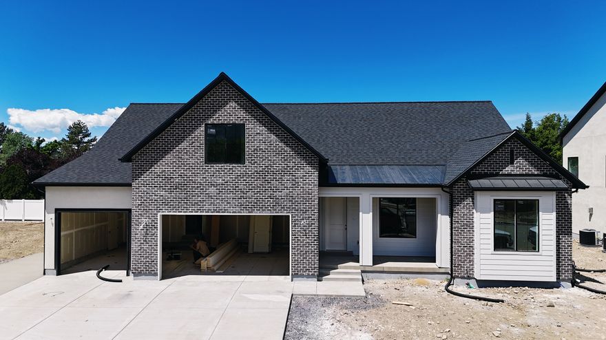 This Transitional styled Rambler with Bonus was designed for this lot in Orem. This home is designed with the family in mind. The bonus area features a large bedroom with walk-in closet a full bath and loft, a perfect hangout for the kids. The Home is set up perfect for a future ADU with Basement entrance and RV parking. The family room is 12' with stacked windows for all the natural light. Cafe appliances, an impressive cabinet package and so much more. Call for your personal showing!
