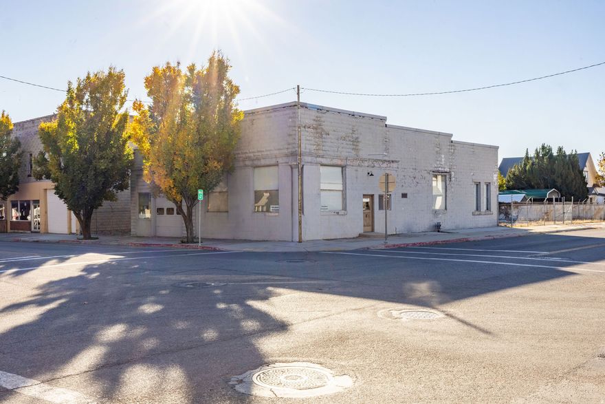 Prime location with great street frontage and a fully fenced yard. This property includes approximately 500 sq. ft. of office space, three large bay doors, a three-phase electrical panel, and a 110-volt sub-panel with a three-phase compressor. Ideal for a machine shop, warehouse, or new business looking to establish in a growing community.